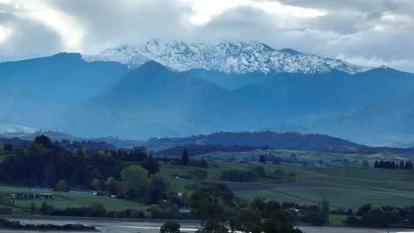 drone shot of snowcapped mount owen looming over the tasman valley, new zealand