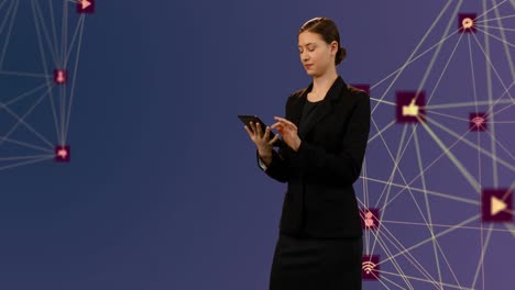 Globe-of-digital-icons-against-businesswoman-using-digital-tablet