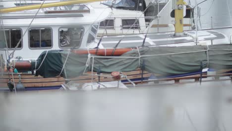 view of the bay with docked boats on a rainy day in ireland, shift focus