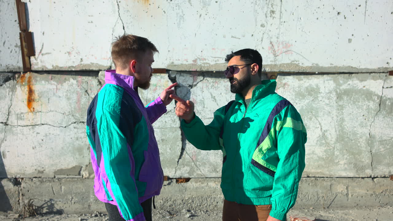 White And Asian Men Negotiating With Finger Gestures Beside Cracked Concrete Wall, Director Guiding Actor