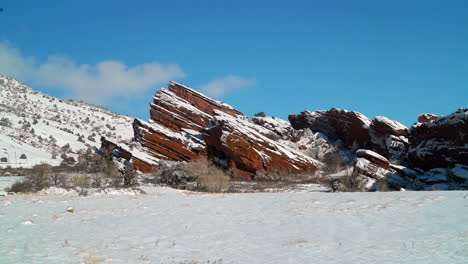 Red-Rocks-Park-Amphitheater-Denver-frozen-fresh-snow-powder-early-sunrise-winter-Colorado-Rocky-Mountain-peak-Morrison-music-blue-bird-early-morning-view-landscape-slow-cinematic-slider-pan