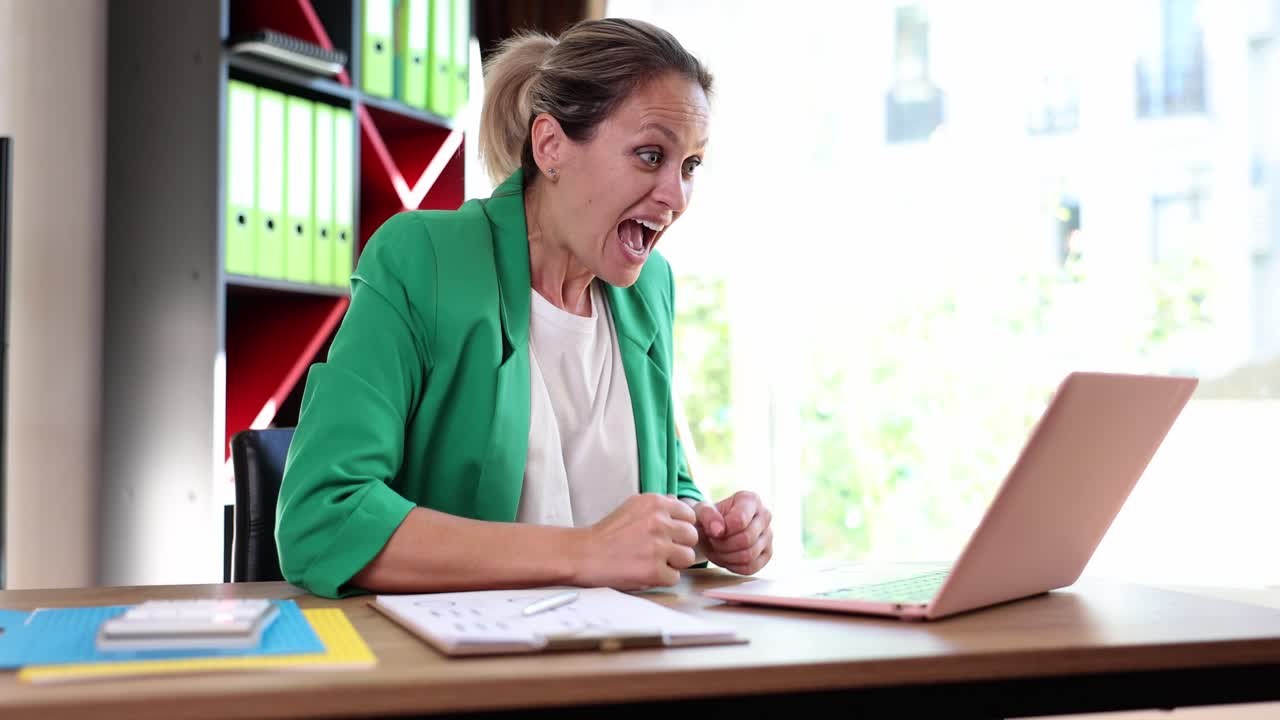 Excited businesswoman celebrates success at the office