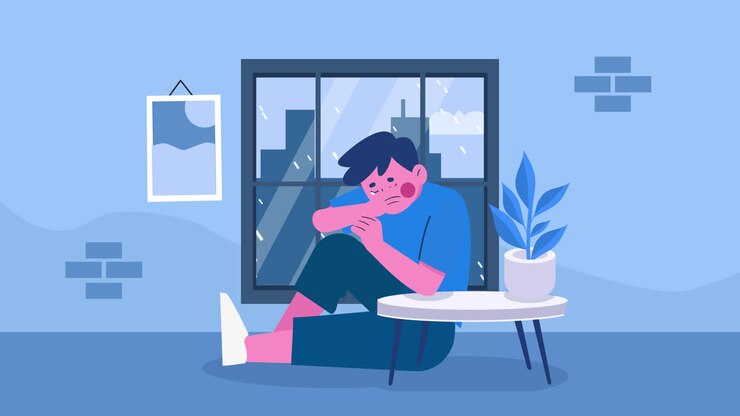 Un garçon triste assis près d'une fenêtre par un jour de pluie.