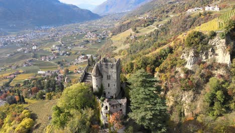 aerial drone over a medieval castle in the middle of the vineyards in italy