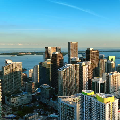 Beautiful skyscrapers in the rays of setting sun. Downtown of Miami, Florida, USA with waterscape at backdrop. Top view.