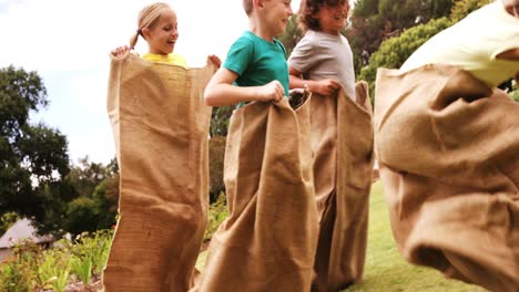 kids having a sack race in park