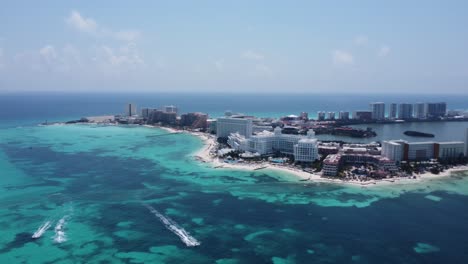 rotating aerial over cancun hotel zone, a haven for sun-seekers and vacation enthusiasts, stunning array of high-rise hotels and resorts that stand like beacons of luxury along the coast