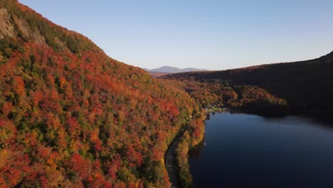 Beautiful-aerial-drone-footage-of-the-fall-leaves-on-and-around-Mount-Hor,-Mount-Pisgah,-and-Lake-Willoughby-during-peak-autumn-foliage-at-Willoughby-State-forest-in-Westmore,-Vermont