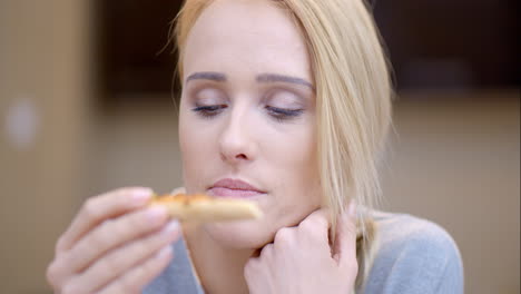 attractive woman eating homemade pizza