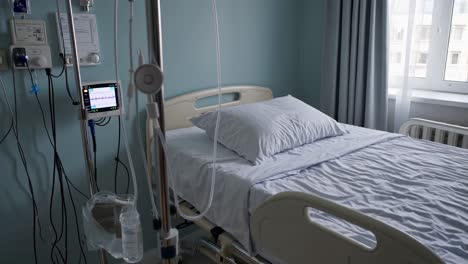 hospital room with empty bed and medical equipment