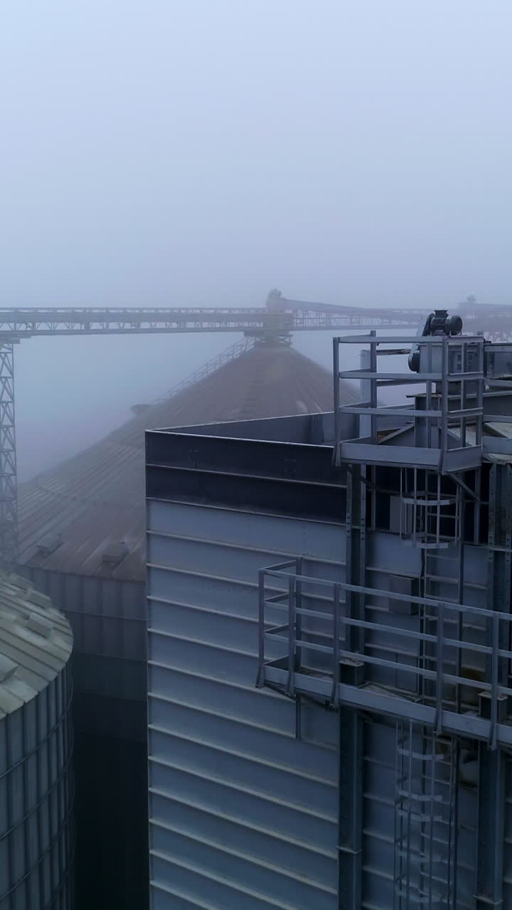 Agricultural huge elevator containers. Big grain elevator containers aerial view. Vertical video