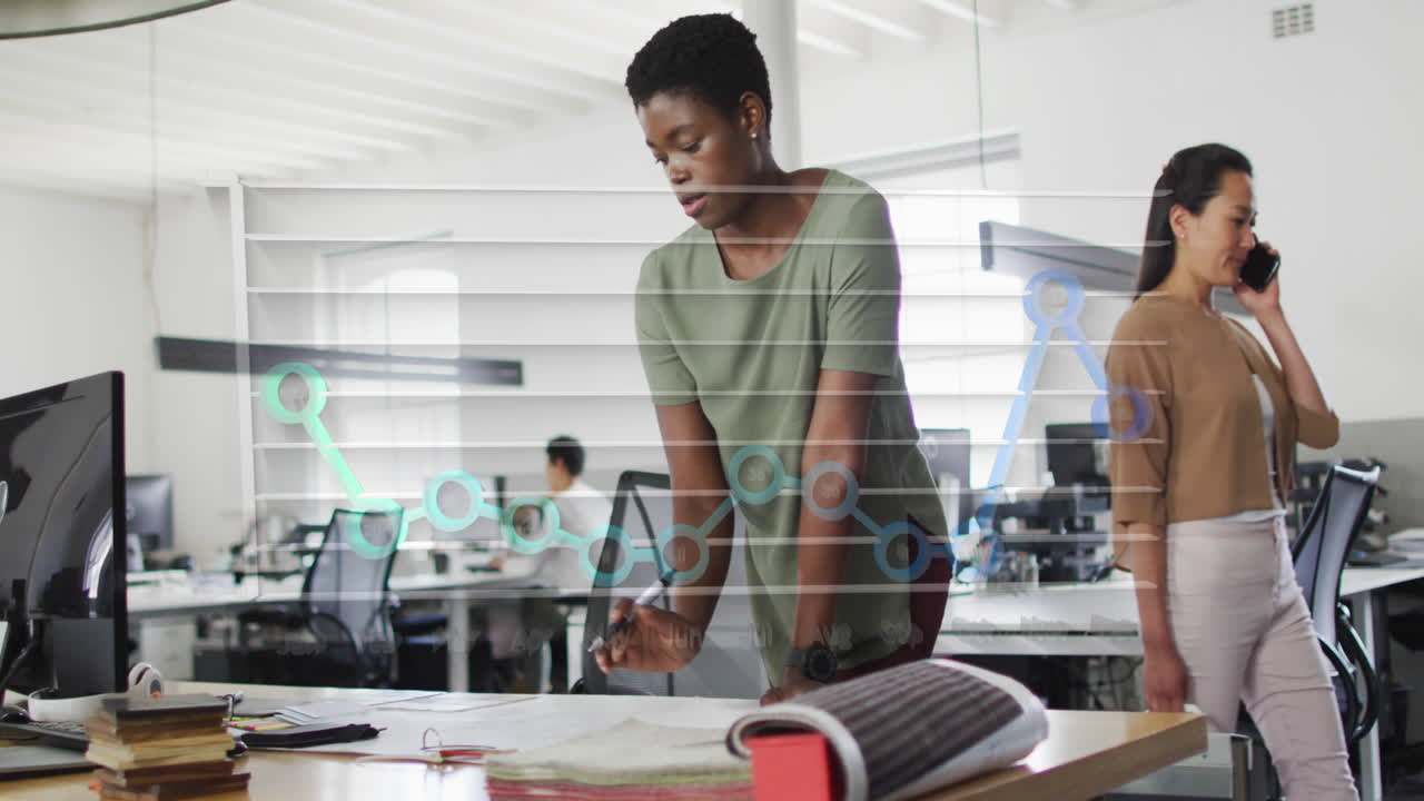 Animation of month names and graph over african american woman working on blueprint in office