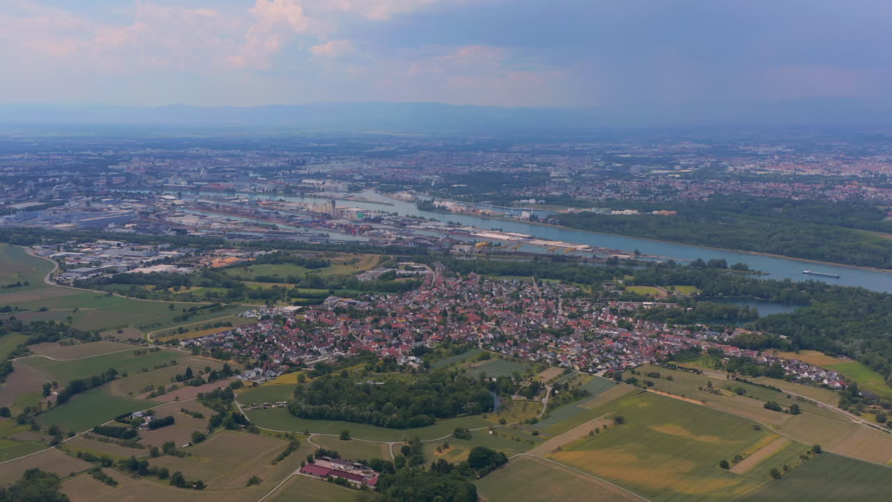 Aerial view of the village 'Auenheim' on the german french border near Kehl Strasbourg on a sunny day. The Rhine port of Kehl and Strasbourg in the background