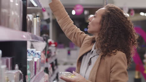woman choosing perfume in beauty shop