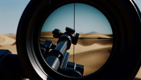 sniper rifle scope view of desert landscape