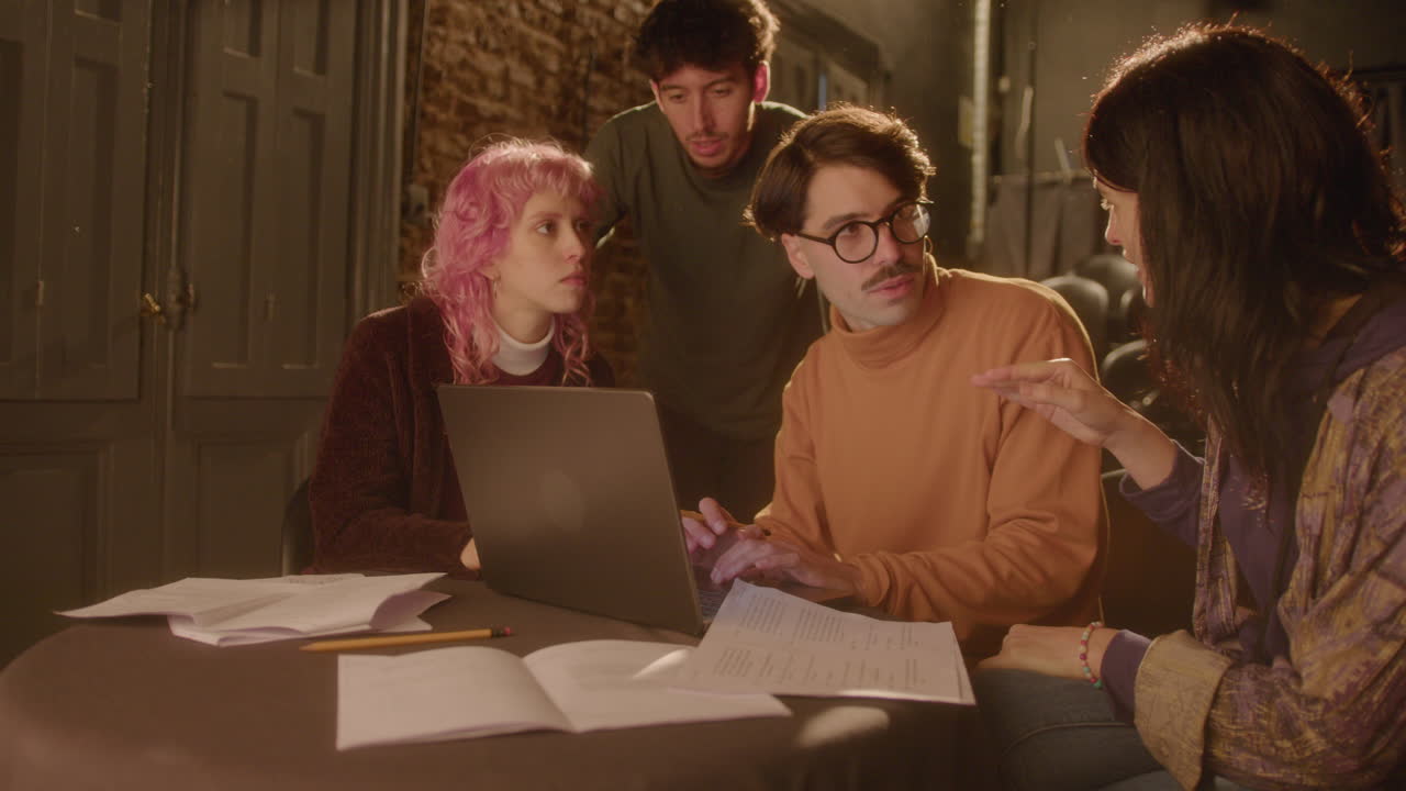 Stage Director and Actors Using Laptop and Discussing Play in Theater
