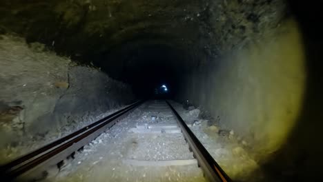 dark tunnel with railroad tracks