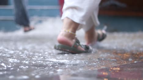 people walking on a wet street during a rain storm