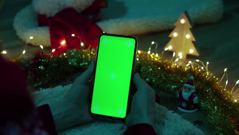 green screen pnone in hands. christmas concept
