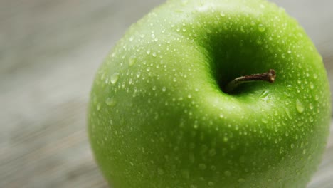 green apple with water drops