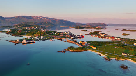 establishing drone shot of the sommaroya island and town, midnight sun in norway