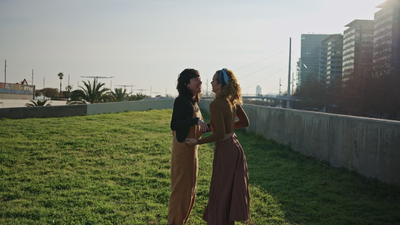 Two women embracing in a city park