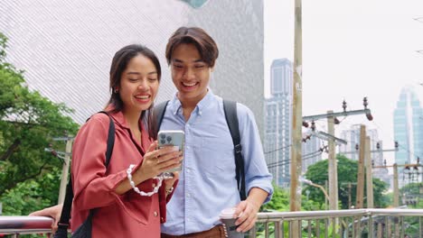 couple using smartphone in city