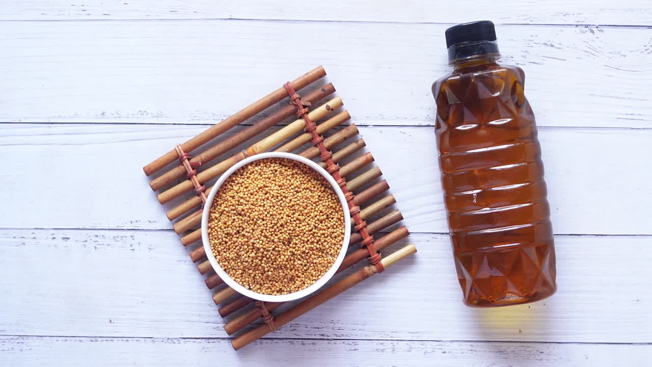 Coking oil and seeds in a container on table
