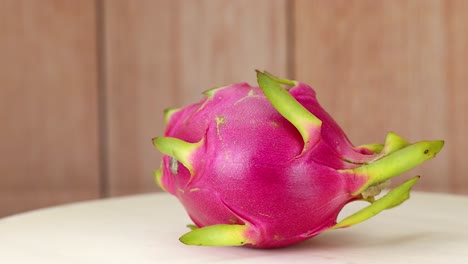 dragon fruit spins on a wooden surface