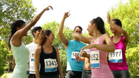 Happy-group-of-friends-cheering-after-running-a-race