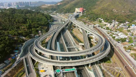 traffic on a massive highway interchange with multiple levels and loop shaped road in hong kong, aerial view