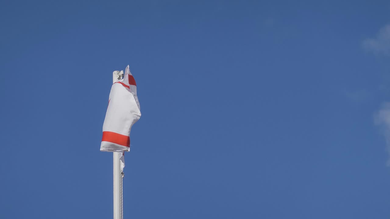 Flag of Turkish Northern Cyprus waving in wind, copy space on right