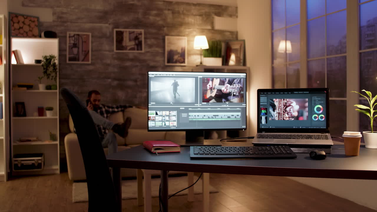 Home Office with Editing Setup and a Man on the Phone