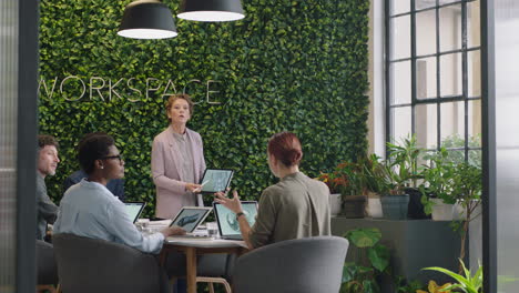 business people meeting caucasian project manager woman showing prototype engine turbine on tablet computer screen presenting design innovation to diverse management group in office boardroom