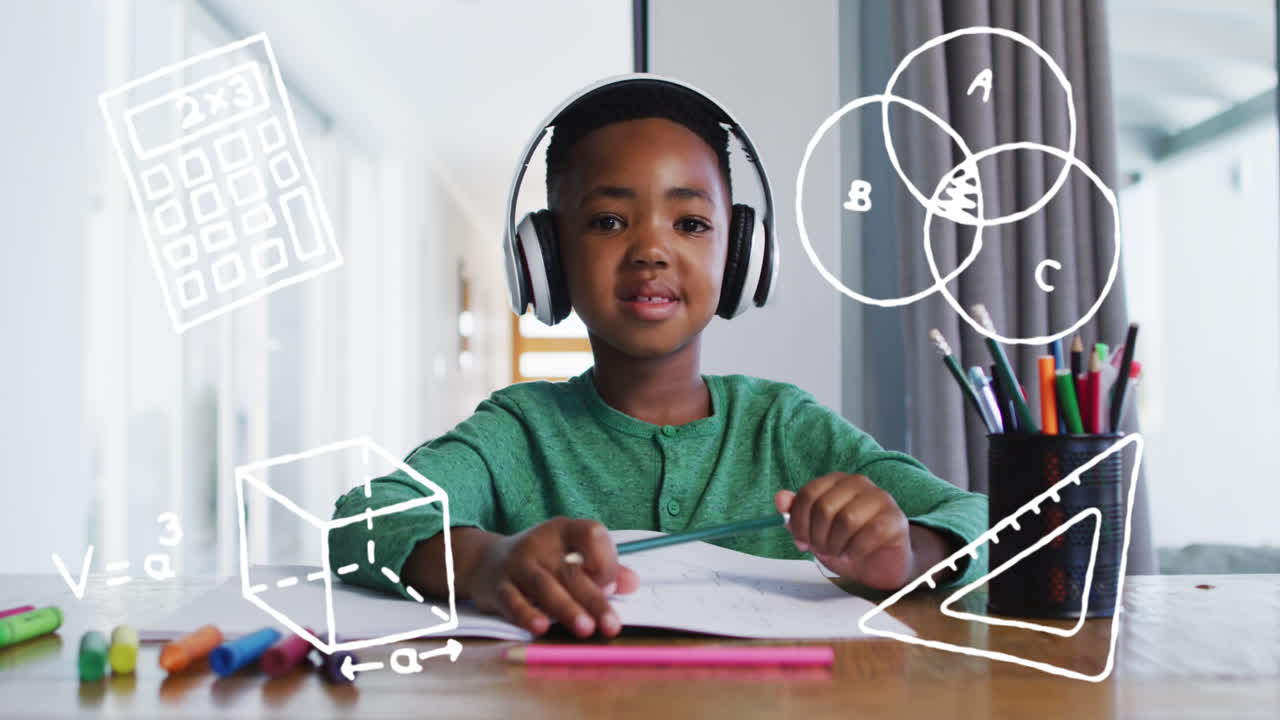 Animation of school icons over smiling african american schoolboy having video call