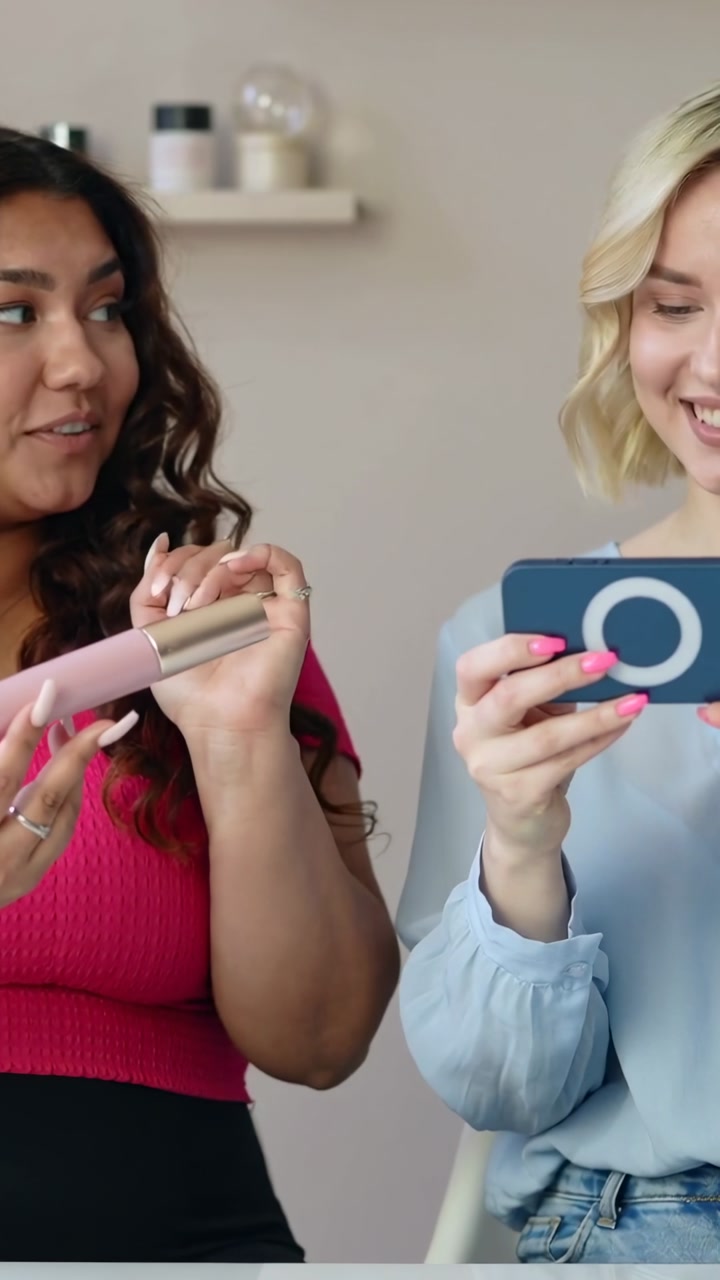 Vertical video: Tapping ringcase phone, right filming as left in pink rotating tube with gold cap