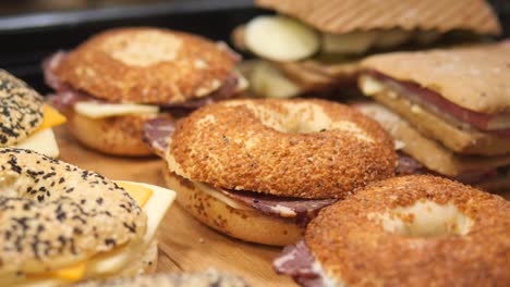 close up of a bagel sandwich with meat and cheese