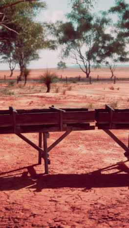 wooden structure in a red dirt desert landscape