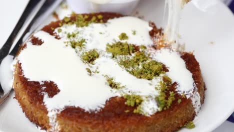 kunafa with a wipe cream on a plate