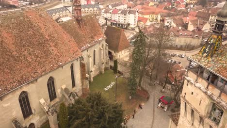 A-drone-shot,-with-forward-motion,-capturing-a-glimpse-of-the-city-of-Sighisoara-on-an-afternoon