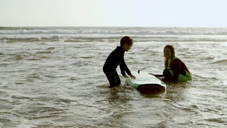 mother helping son standing on board