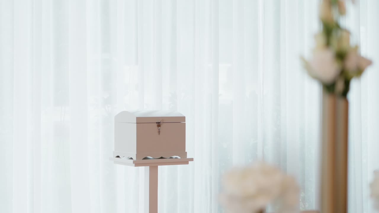 closed wooden box on a stand with latch used for collecting wedding wishes or envelopes