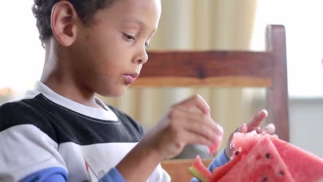 Little-boy-eating-sweet-red-watermelon-stock-footage-2