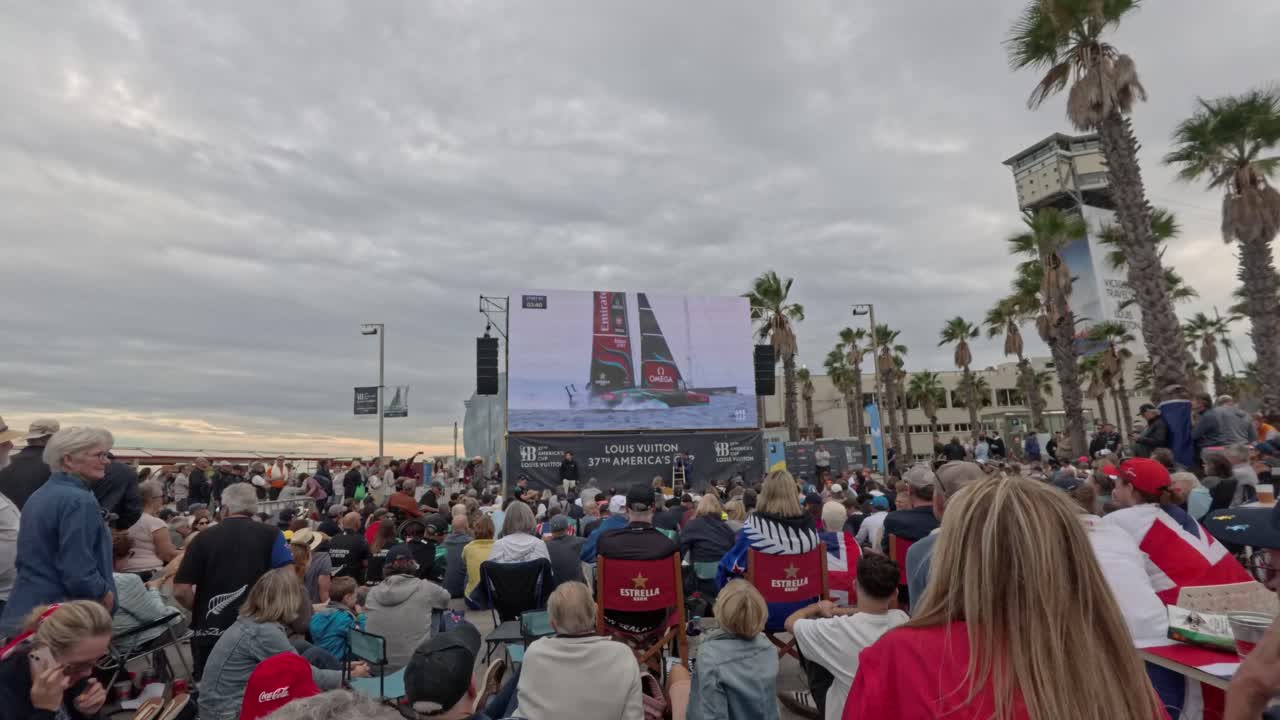Crowd outside watching the 37th America´s cup on a giant screen. Celebrations