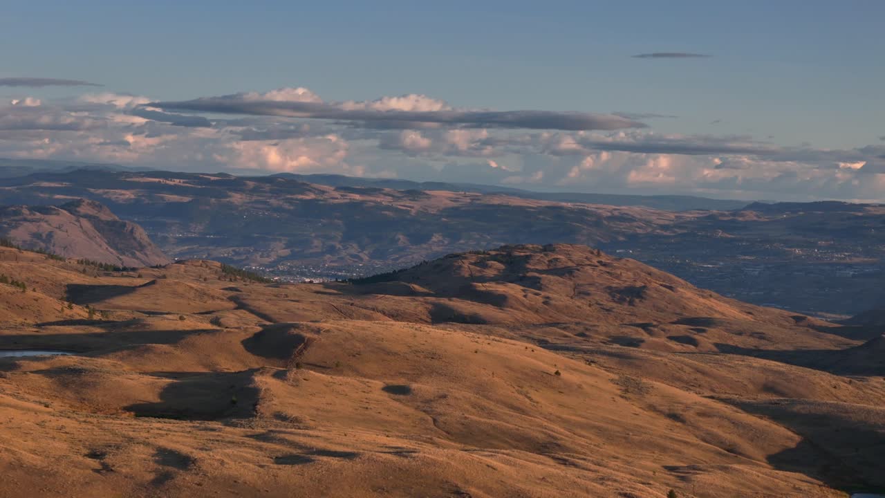 Dusk's Embrace: Aerial Scene of Sunset Over the Grassland surrounding small town and Hills