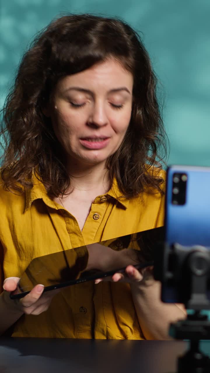 Woman Vlogger Presenting Tablet to Smartphone Camera
