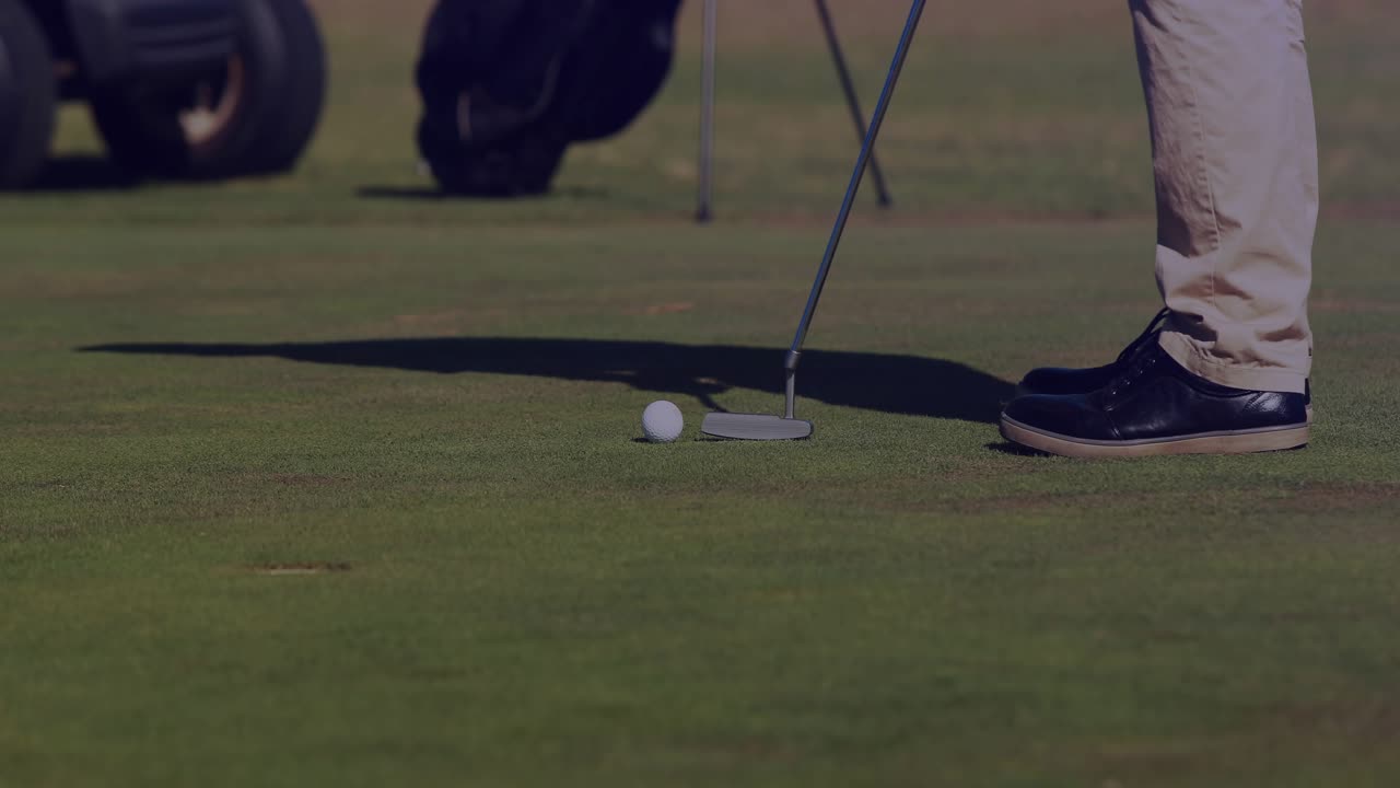 Golfer aligning putter, steadying then striking ball, sending leftward roll toward cup to sink
