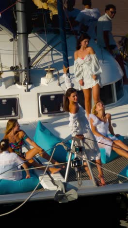 smiling friends sitting on yacht deck
