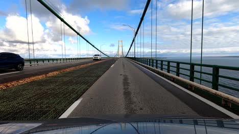 driving over mackinaw bridge in michigan, point of view