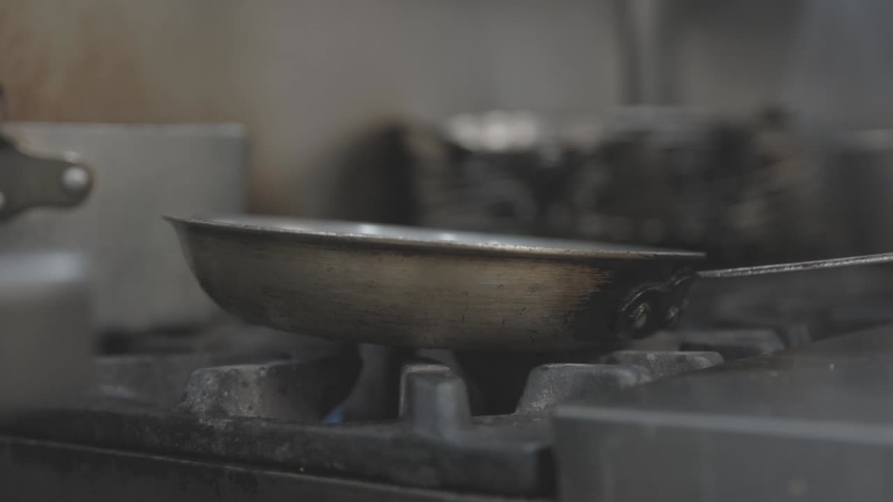 A commercial stove is turned on, producing a dramatic burst of flames from the burner